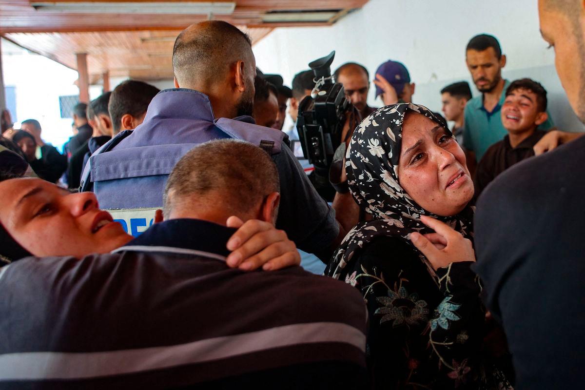 Relatives mourn the death of three Palestinian journalists reportedly killed in Israeli bombardment in the yard of the Ahli Arab Hospital, in Gaza City. AFPPIX