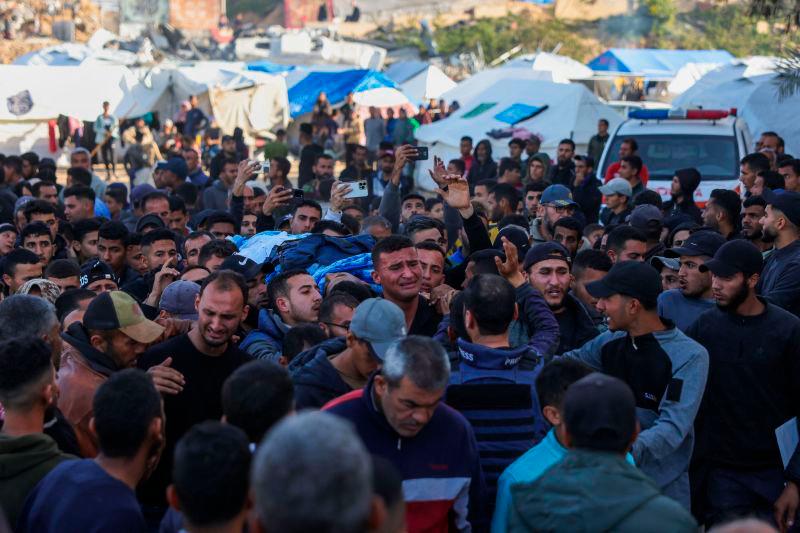 Relatives and colleagues carry the body of Palestinian journalist Hussam Shabat, who collaborated with Al Jazeera Mubasher, during his funeral in Beit Lahia, in the northern Gaza Strip, on March 24, 2025. AFPpix