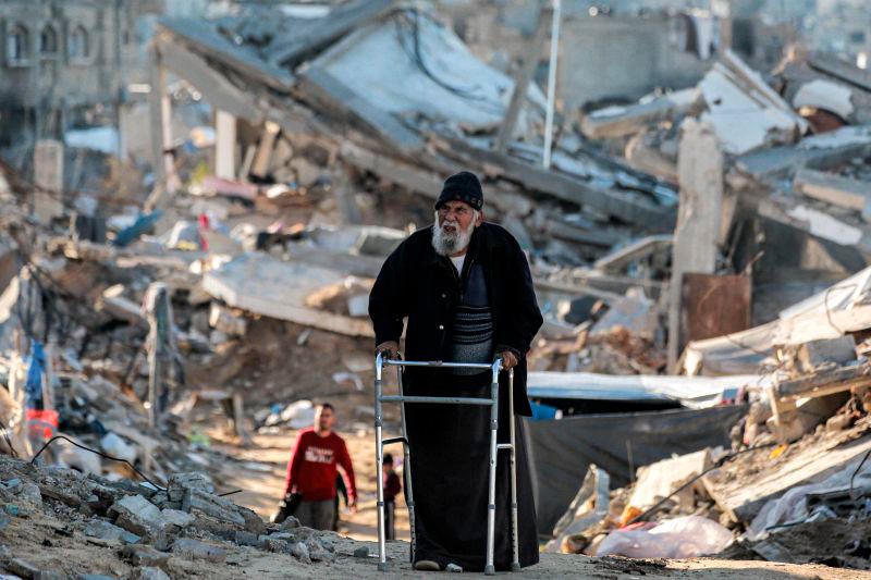 For representational purposes - An elderly man moves with a walker past rubble along a broken road as people displaced by conflict from Beit Lahia arrive in Gaza City. AFPpix