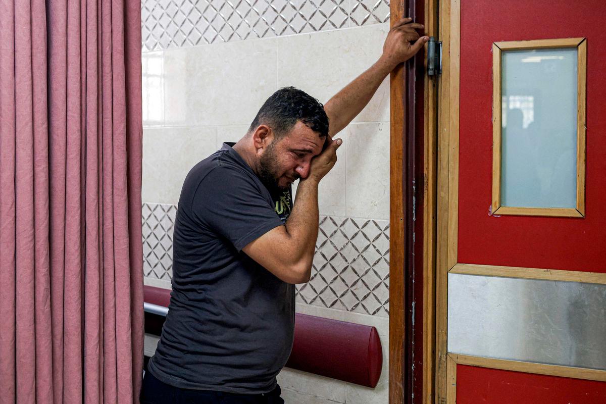 A relative reacts as the body of Thameen Dawabsheh, 35-year-old Palestinian reportedly killed by settler gunfire in Duma, south of Nablus, is moved from Rafidiya hospital in the occupied West Bank city of Nablus on August 13, 2025. (Photo by JAAFAR ASHTIYEH / AFP)