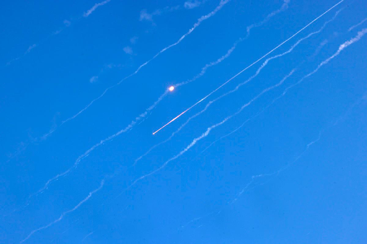 Missiles fired from Iran are pictured over Hebron in the occupied West Bank on June 19, 2025. Israel’s foreign ministry reported a direct hit on a hospital in the south on June 19, after Iran fired a fresh salvo of missiles at the country. - HAZEM BADER / AFP