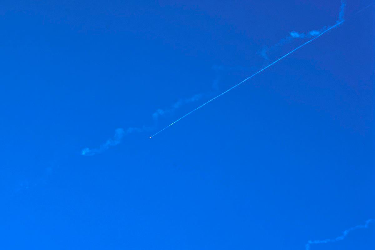 A missile fired from Iran leaves a trail in the sky above nablus city in the occupied West Bank on June 19, 2025. - Zain JAAFAR / AFP