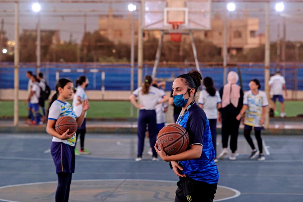 Palestinian referee Amira Ismail trains young basketball players at Champions Academy in Gaza City on October 4, 2021.AFPpix