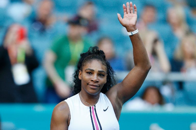Serena Williams acknowledges the crowd after a 2nd round victory over Rebecca Peterson at the Miami Open, but Saturday pulled out of the WTA/ATP event with a left knee injury. — AFP