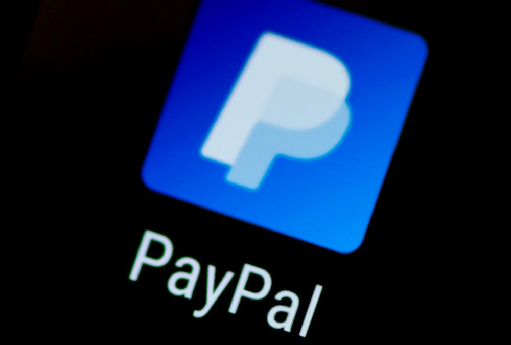The PayPal app logo seen on a mobile phone. The company has 346 million active accounts around the world and processed US$222 billion in payments in the second quarter. – REUTERSPIX