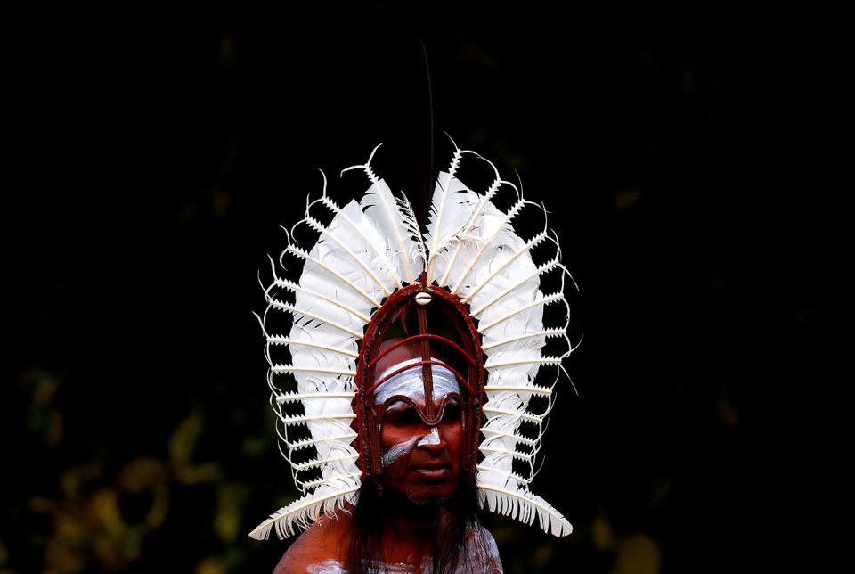 An indigenous man from the Torres Strait Islands wears a traditional dress as he performs during a welcoming ceremony at Government House in Sydney, Australia, June 28, 2017. REUTERSPIX