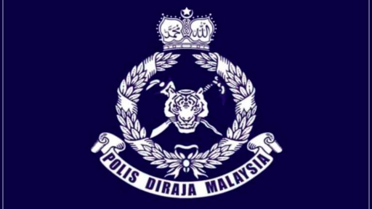 Two men wearing uniforms with police ranks, Malaysian coat of arms fined