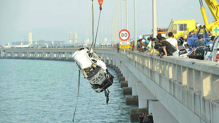 The SUV which plunged off the Penang Bridge was hoisted out of the sea by crane on Jan 22, 2019.