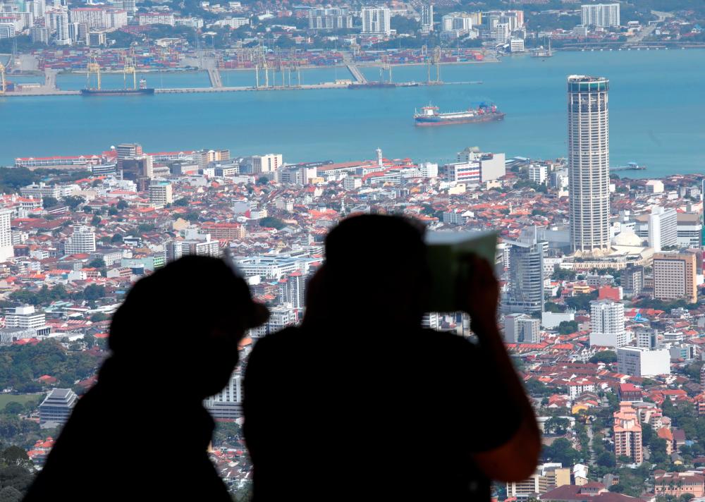 Visitors to Bukit Bendera in George Town getting a bird’s eye view of Penang city centre. Domestic tourism has seen an uptick since the interstate travel ban was lifted. Masry Che Ani/THESUNpix