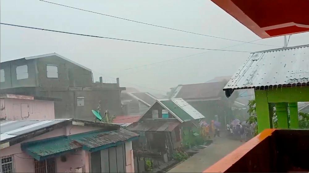 People walk as Typhoon Kammuri, known locally as Typhoon Tisoy, makes landfall in Gamay, Northern Samar, Philippines, December 2, 2019, in this still image from video obtained via social media. - Reuters