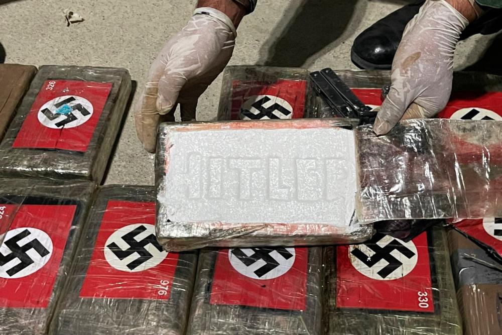 This handout picture released by the Peruvian National Police shows the police showing the 58 kilos of cocaine branded with the Nazi swastika and engraved with Hitler’s name seized in a Liberian-flagged container ship docked in the northern port of Paita, Peru, on May 25, 2023/AFPPix