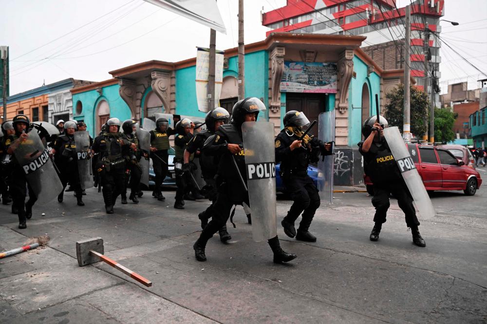 Supporters of Peruvian President Pedro Castillo clash with the police to reach the Lima Prefecture, where Castillo is alleged to be, in Lima, on December 7, 2022. AFPPIX