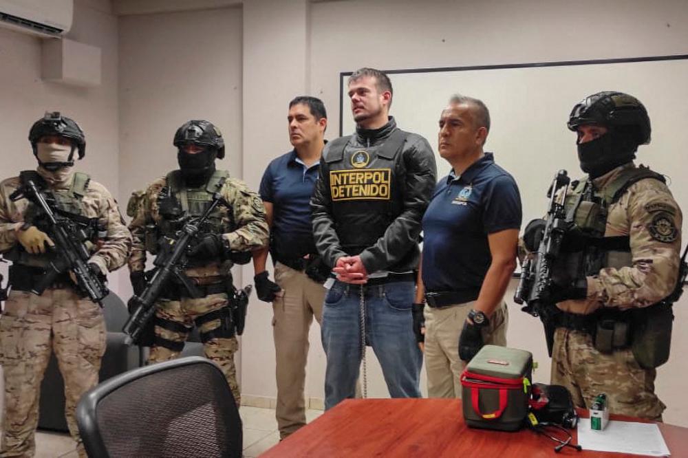 This handout picture released by Interpol Peru shows Peruvian police and Interpol agents handing over Dutch Joran Van der Sloot to FBI agents for a temporary extradition to the United States in Callao, Peru on June 8, 2023. AFPPIX