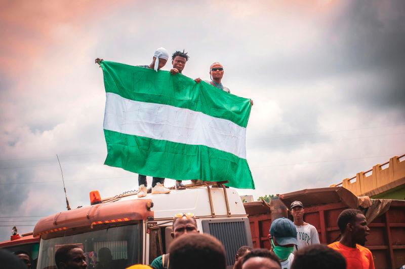 For visual purposes only- People holding Nigerian flag. PEXELSpix