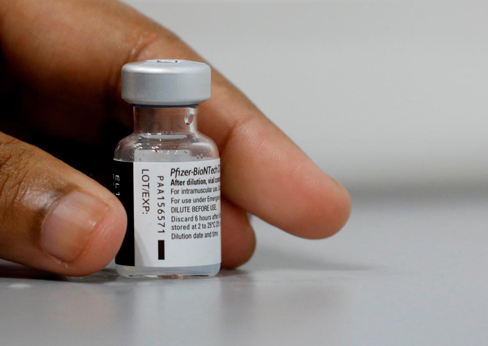 A medical worker prepares to dilute a vial of Pfizer-BioNTech vaccine at a coronavirus disease (Covid-19) vaccination center in Singapore March 8, 2021. — Reuters