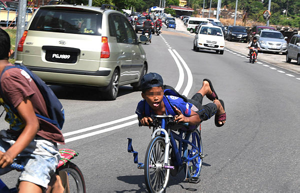 Filepix taken on Mar 22 shows a teenager riding dangerously a ‘lajak’ bicycle in Air Itam, George Town. — Bernama