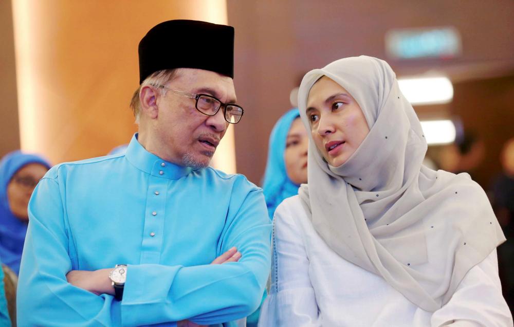 Datuk Seri Anwar Ibrahim (L) and his daughter Nurul Izzah Anwar.