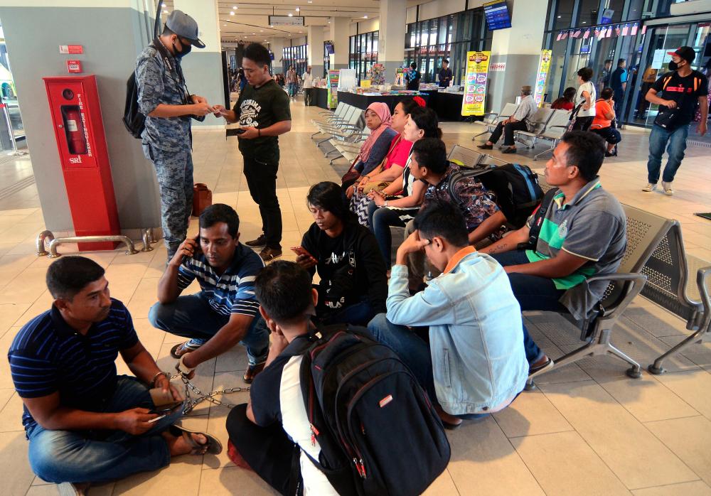 Some of the 18 foreigners who were rounded up by the Penang Immigration Department in Penang Central today. - Bernama