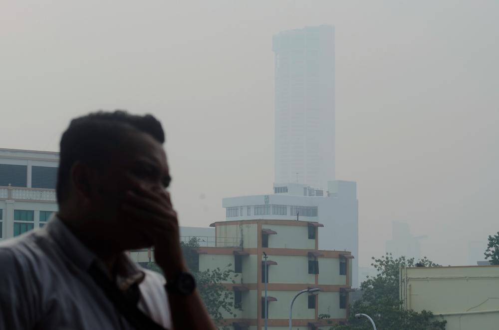 The Komtar building in George Town surrounded by haze today. - Bernama