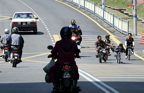 Filepix taken on Mar 22 shows a group of teenagers performing “mat lajak” stunts on their bicycles.