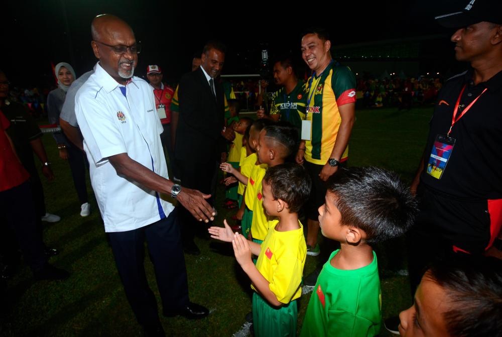 Rural Development Deputy Minister R. Sivarasa (L) greets children during Hari Potensi Kemas at Universiti Sains Malaysia, in George Town last night. - Bernama