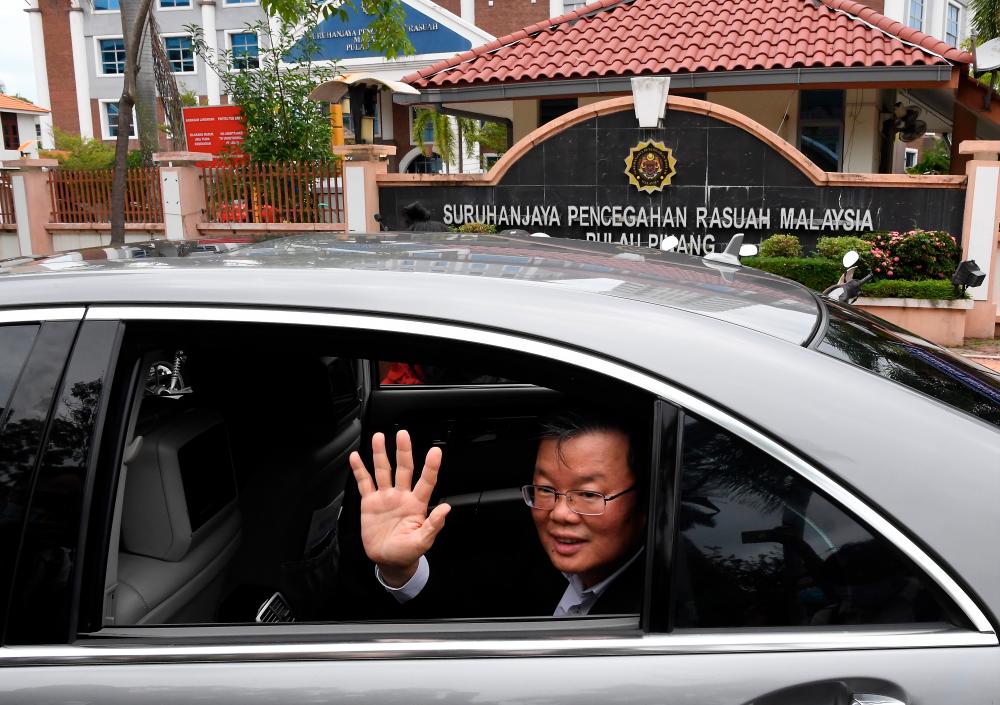 Penang Chief Minister Chow Kon Yeow waves his hand at the media after leaving the MACC office on Jalan Sultan Ahmad Shah in George Town today. - Bernama