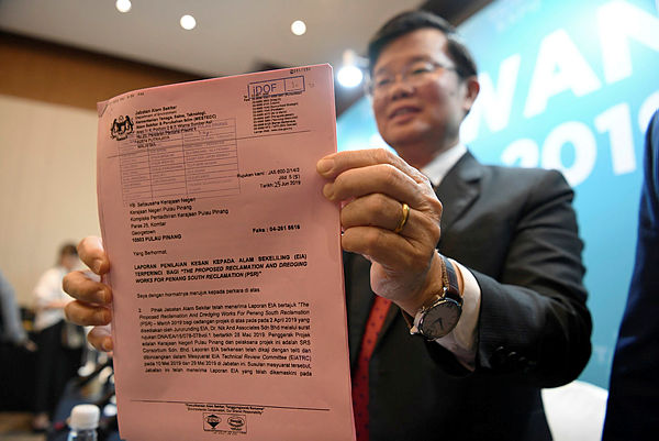 Filepix take on July 5, shows Chief Minister Chow Kon Yeow holding the Environmental Impact Assessment (EIA) pass report for the Penang South Reclamation (PSR) project.