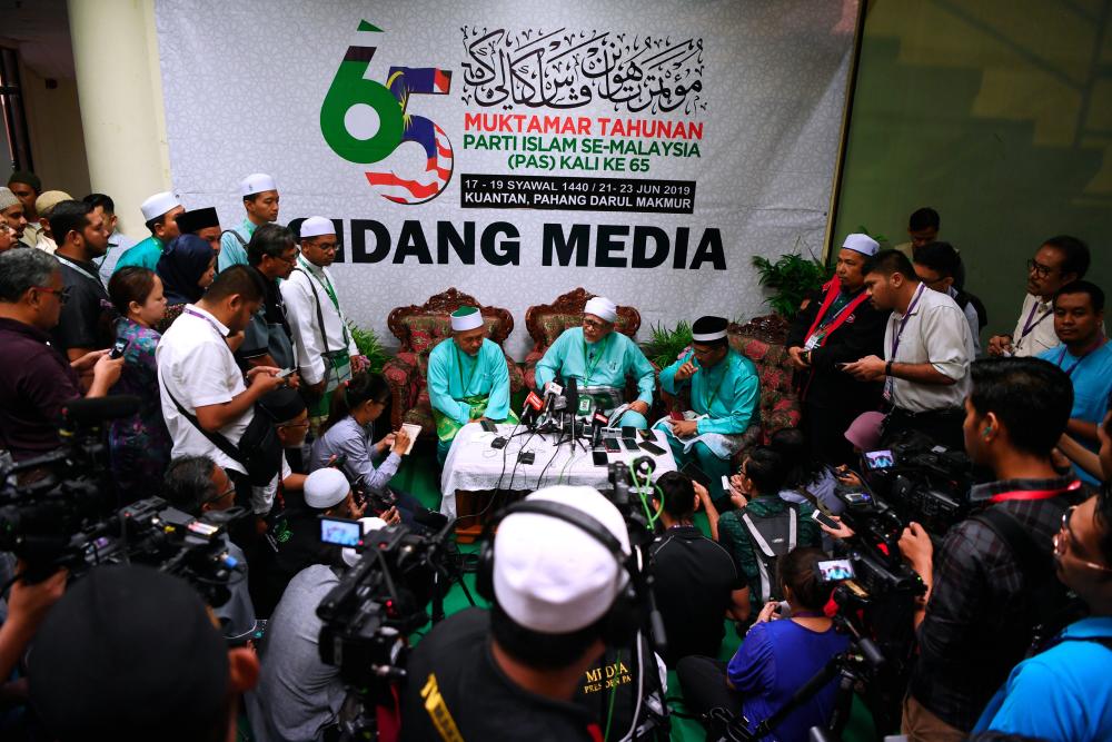 PAS party president Datuk Seri Abdul Hadi Awang speaks to members of the media after delivering his presidential speech at the 65th PAS general assembly at the Sukpa Indoor Stadium, Kuantan on June 21, 2019. - Bernama