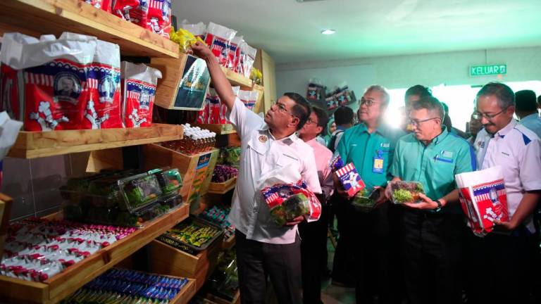 Domestic Trade and Consumer Affairs Minister Datuk Seri Saifuddin Nasution Ismail (L) checking the food provided to students during the opening of the Food Bank Siswa programme in Universiti Malaysia Pahang (UMP) on Oct 16, 2019. — Bernama
