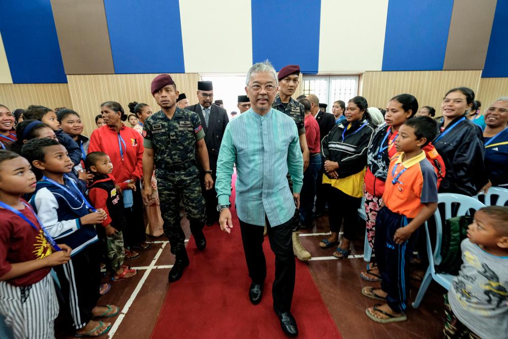 The Yang di-Pertuan Agong Al-Sultan Abdullah Ri'ayatuddin Al-Mustafa Billah Shah is greeted by the Sungai Ruli Orang Asli community during a visit, on sept 8, 2019. — Bernama