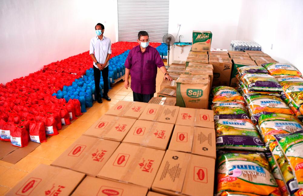 Communications and Multimedia Minister Datuk Saifuddin Abdullah (R), who is also the Indera Mahkota MP, inspects the food supply during a visit to the Covid-19 relief goods storage hub for the Indera Mahkota parliamentary constituency today. - Bernama