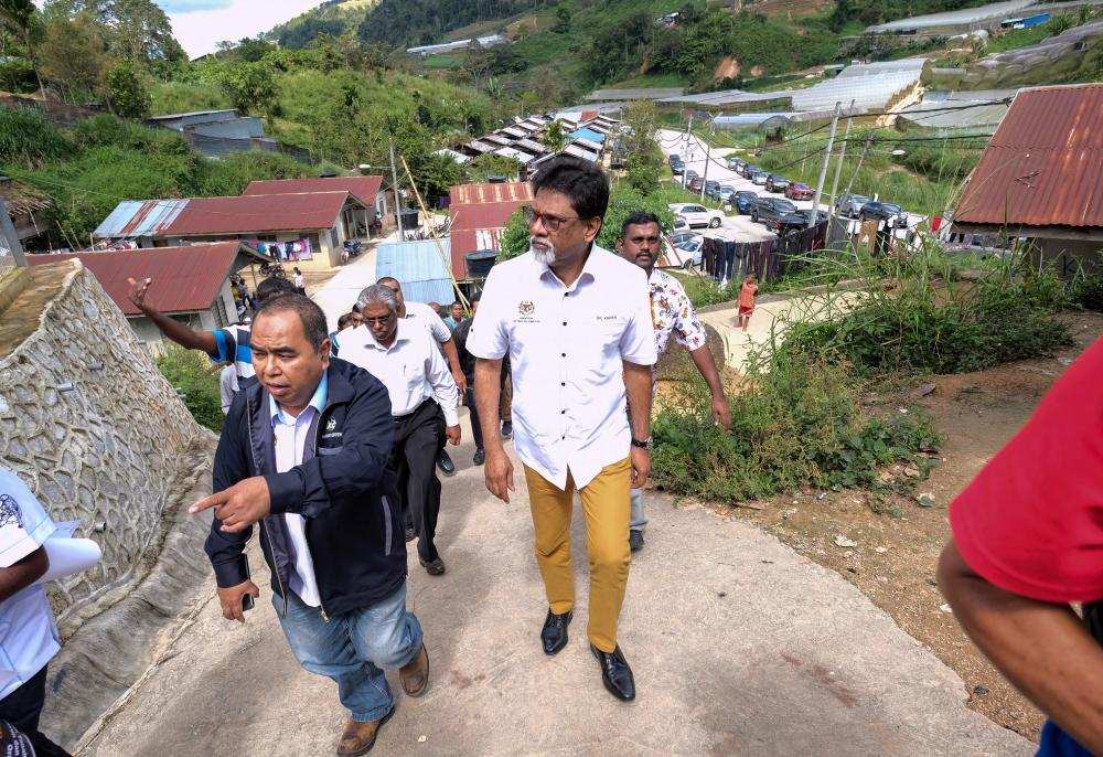 Water, Land and Natural Resources Minister Dr Xavier Jayakumar (R) is having a look at the village environment during a survey at Kampung Orang Asli Sungai Tiang, on Jan 5, 2018. — Bernama