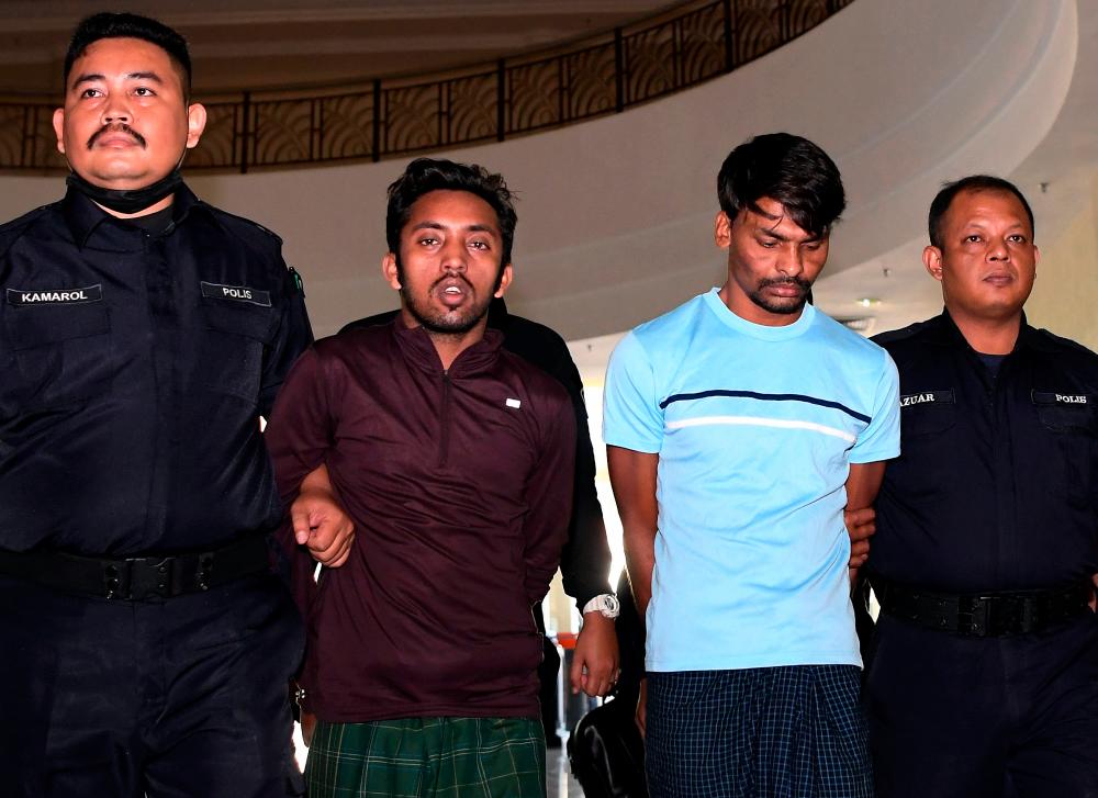 Two Myanmar workers, Hamid Husin Mohd Husin, 32, and Mohd Karim Hosain, 28, were charged in the Kuantan magistrate’s court today on charges of killing their Bangladeshi supervisor, Abdul Kader, 40. - Bernama