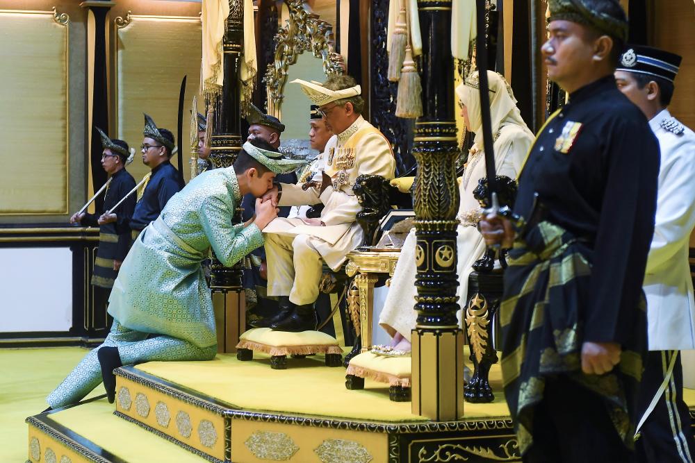 Pahang Crown Prince Tengku Hassanal Ibrahim Alam Shah kisses the hand of his father Pahang Sultan Abdullah Ri’ayatuddin Al-Mustafa Billah Shah during a ceremony at at Balairung Seri, Istana Abu Bakar in Pekan on Jan 29, 2019. — Bernama