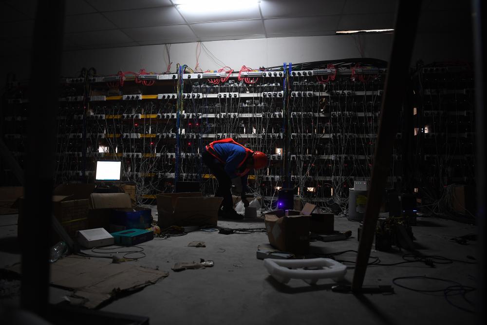 TNB personnel inspect the electrical distribution network of a Bitcoin mining operation during a raid as part of TNB Kuantan Bitcoin Ops on Aug 6, 2019. - Bernama