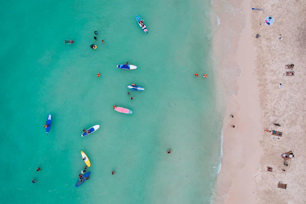 FILE PHOTO: People relax along White Beach amid the coranavirus disease (Covid-19) outbreak, in Boracay Island, Aklan province, Philippines, December 1, 2021. Picture taken with drone. REUTERSpix