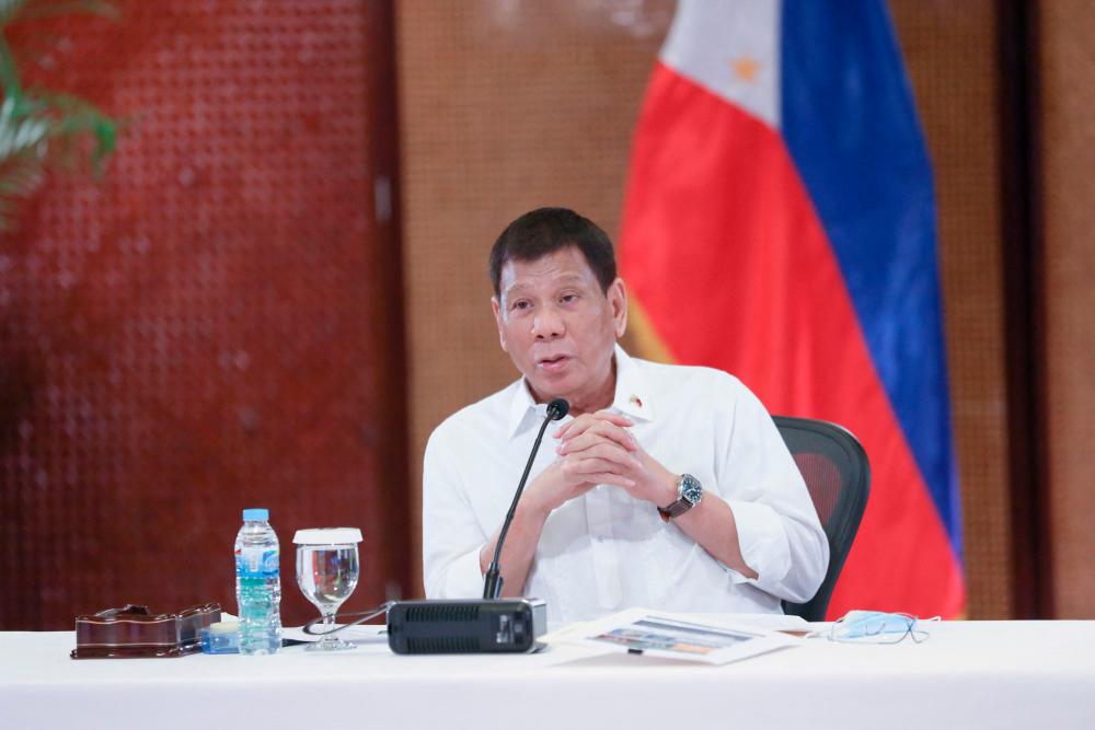 In this handout photo taken on September 15, 2021 and received from the Presidential Photo Division (PPD) on September 16, Philippine President Rodrigo Duterte speaks to members of Inter-Agency Task Force on the Emerging Infectious Diseases (IATF-EID) prior to his talk to the people at the Malacañang Palace in Manila. AFPpix