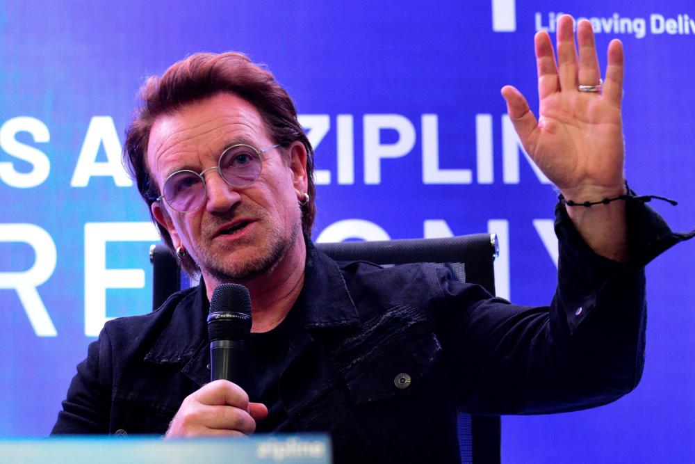 U2 frontman singer Bono speaks to the media during a signing ceremony in Manila on Dec 10. — AFP