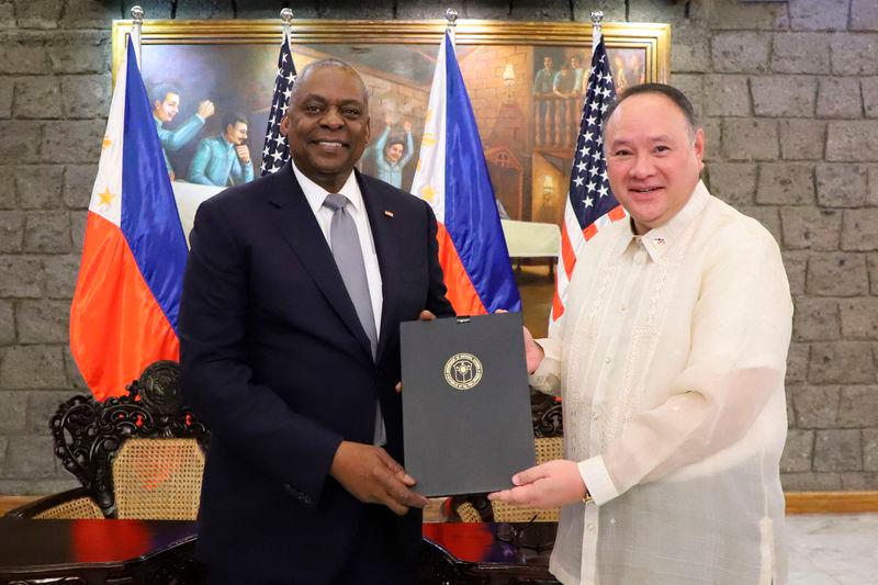 US Secretary of Defense Lloyd Austin (L) and Philippine Defense Secretary Gilberto Teodoro posing after signing the General Security of Military Information Agreement (GSOMIA) at Camp Aguinaldo in Quezon City, Metro Manila - AFPpix