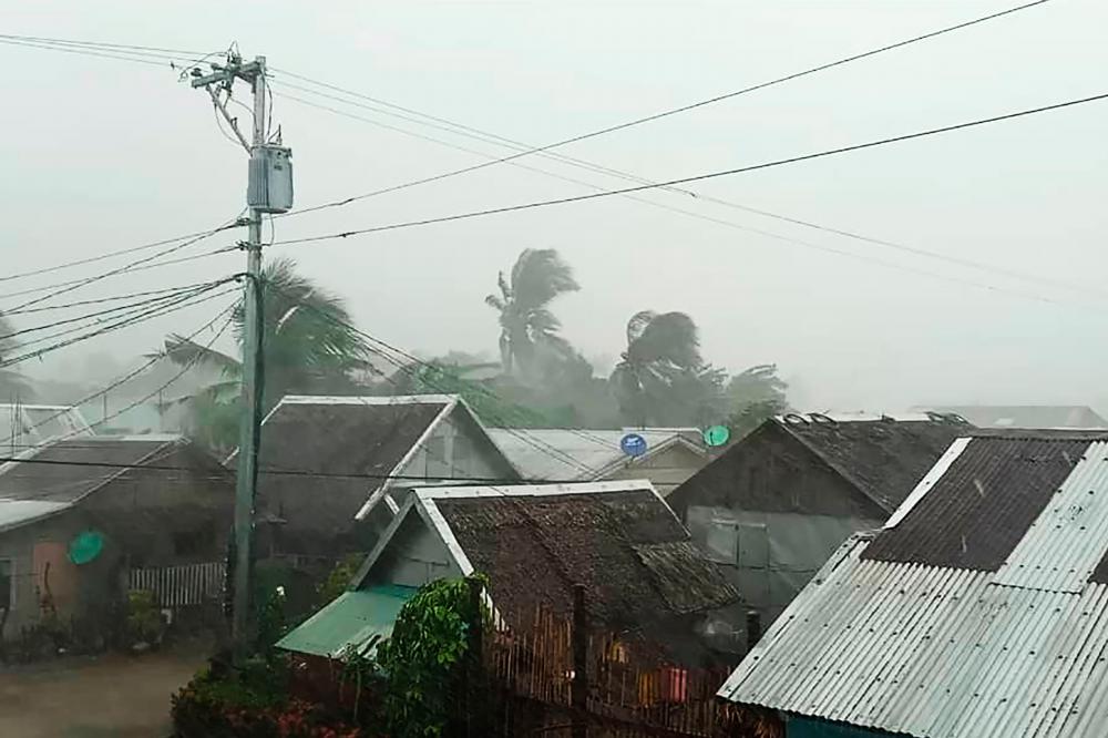 Heavy rains and moderate wind batter houses in Gamay town, Northern Samar province, central Philippines on December 2, 2019, as Typhoon Kammuri hits the province. - AFP