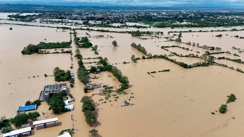 This aerial photo shows houses submerged in flood due to the heavy rains brought about by Tropical Storm Trami in Tuguegarao City, province of Cagayan on October 25, 2024. Philippine rescue workers battled floodwaters on October 25 to reach residents still trapped on the roofs of their homes as Tropical Storm Trami moved out to sea after killing at least 40 people. - John Dimain / AFP