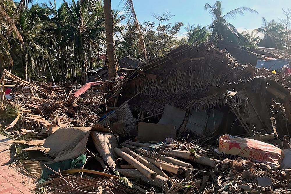 This handout photo taken on Dec 26, and received on Dec 29 courtesy of Dave Kendall shows fallen trees and a building damaged by Typhoon Phanfone, on the Philippine island of Boracay. — AFP
