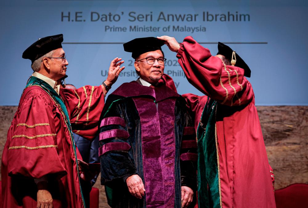Prime Minister Datuk Seri Anwar Ibrahim (middle) has been conferred the degree of Doctor of Laws, honoris causa by the University of the Philippines (UP) in a ceremony held at the university's Villamor Hall, today/BERNAMAPIX