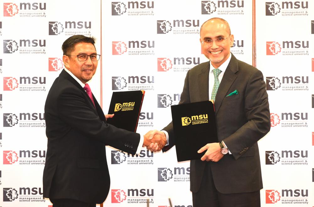 MSU President Prof Tan Sri Mohd Shukri Ab Yajid (right) and Layang Layang Flying Academy Chairman Datuk Seri Azharuddin Abdul Rahman solidifying their academic and industry partnership.
