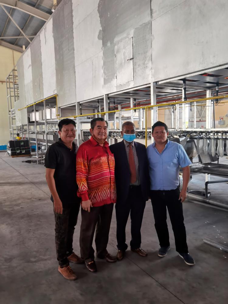From left: Yoek Leong, Tan, Mohamad Fuzi and Xiong Sheng at the glove factory
