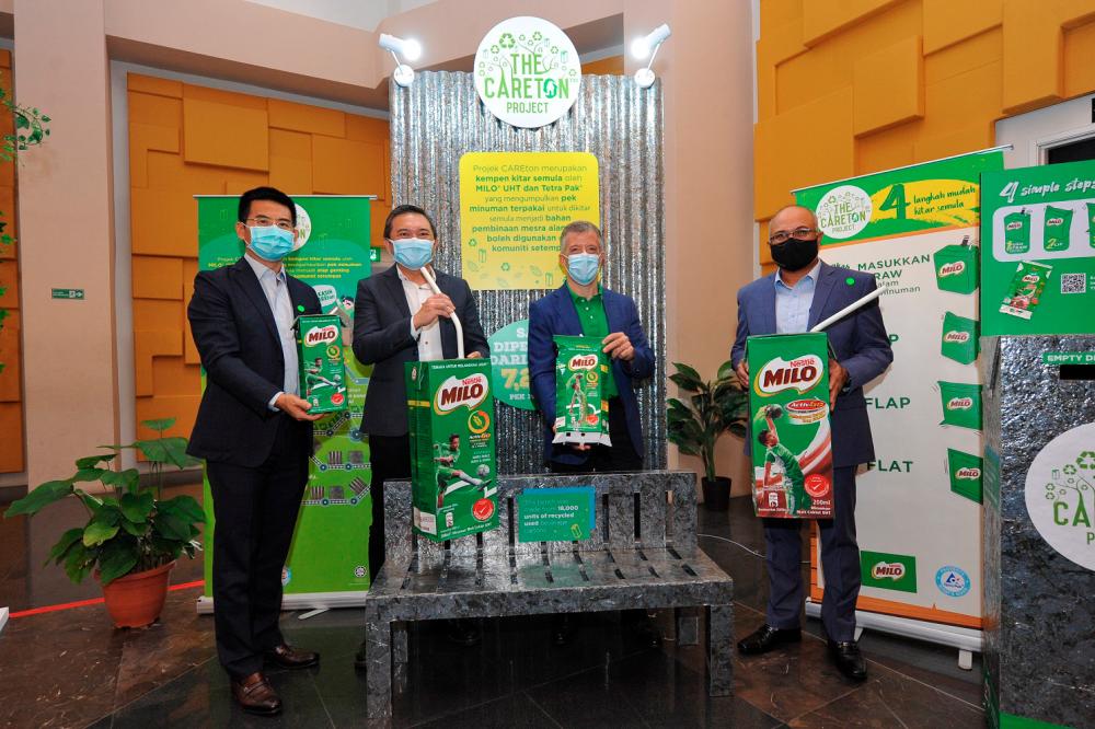 (from left) Wu, Ng, Aranols and Mohd Sayuthi showcasing MILO Ready-to-Drink packaging and CAREton bench made out of recycled used beverage cartons.