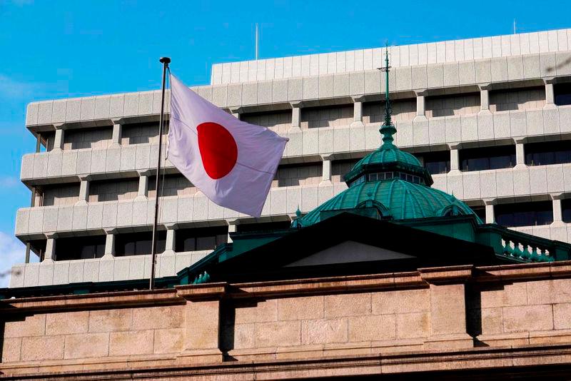 The national flag flutters at the Bank of Japan headquarters in Tokyo on January 23, 2024. - AFPPIX