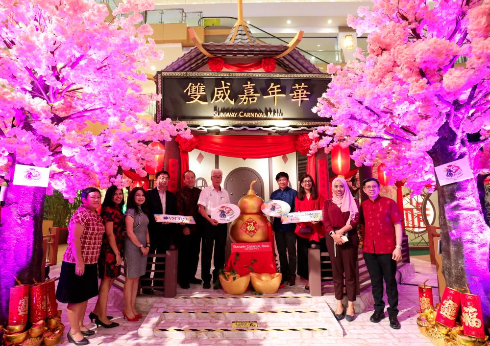 Phee (sixth from left) and Chai (fourth from right) with the mall’s staff at the launch of the “Bank of Luck”. SUNPIX by MASRY CHE ANI