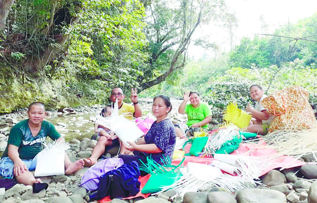 Paren (in black) working with other members of her community at their ‘outdoor workshop’.