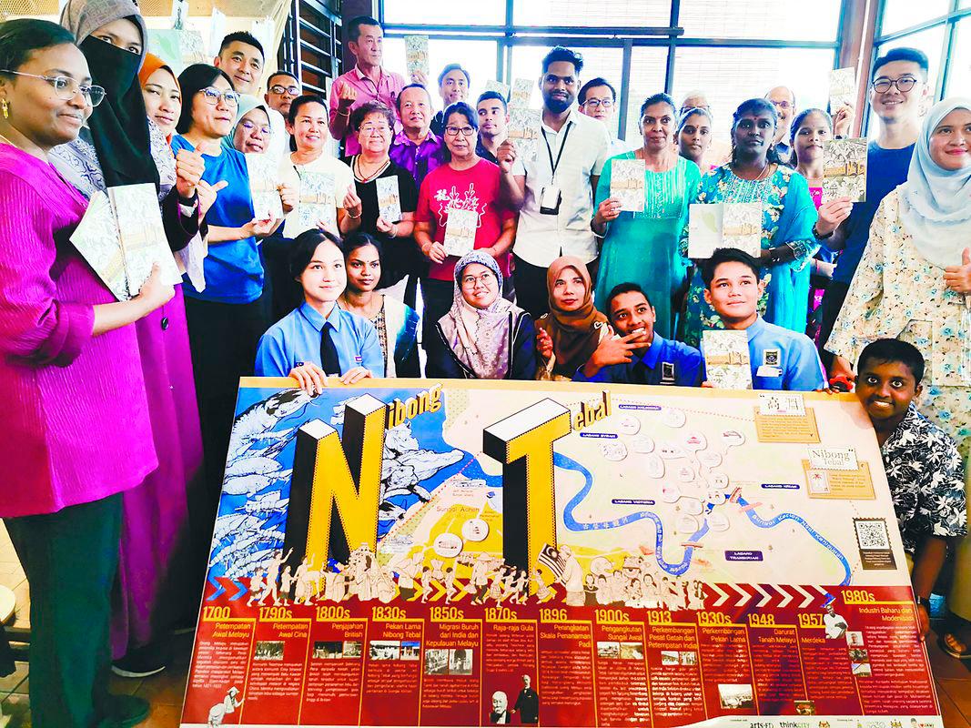 Chen (standing, fourth from left) with residents and members of the project team. – T.C. KHOR/THESUN